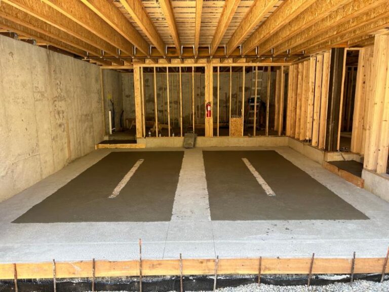 Garage renovation with framing, concrete floor, and foundation structural work