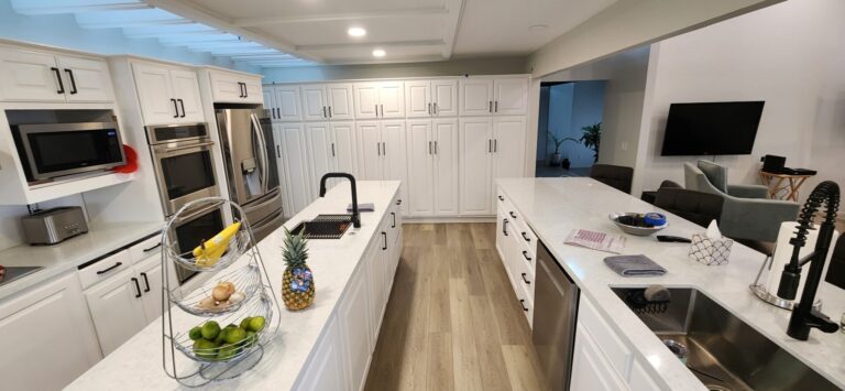Kitchen remodel with white cabinets and dual islands