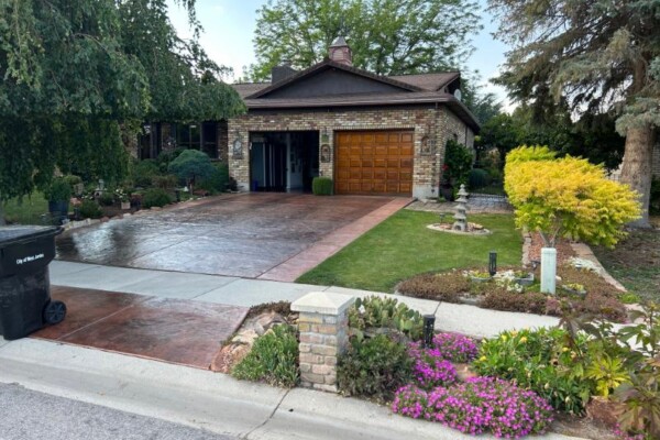 A well-built driveway that elevates the entire property—blending structure, texture, and landscape harmony. Professional concrete contractor color stamped driveway